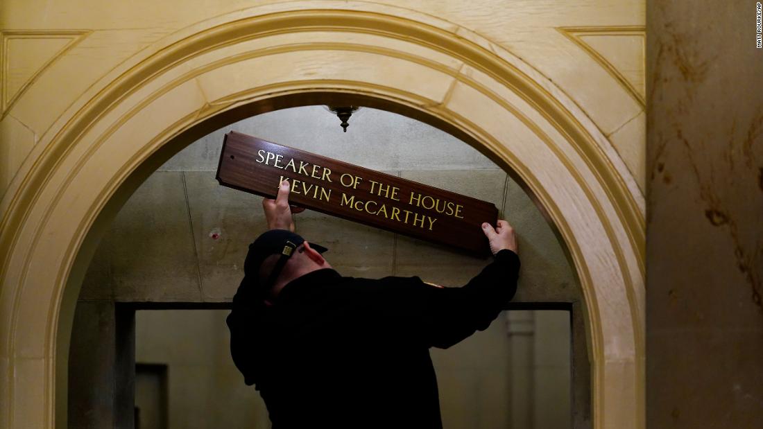 A worker replaces a sign over McCarthy&#39;s office on Saturday.