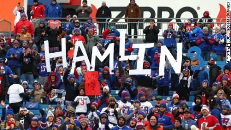 Buffalo Bills fans hold signs in support of Damar Hamlin prior to Sunday&#39;s game.