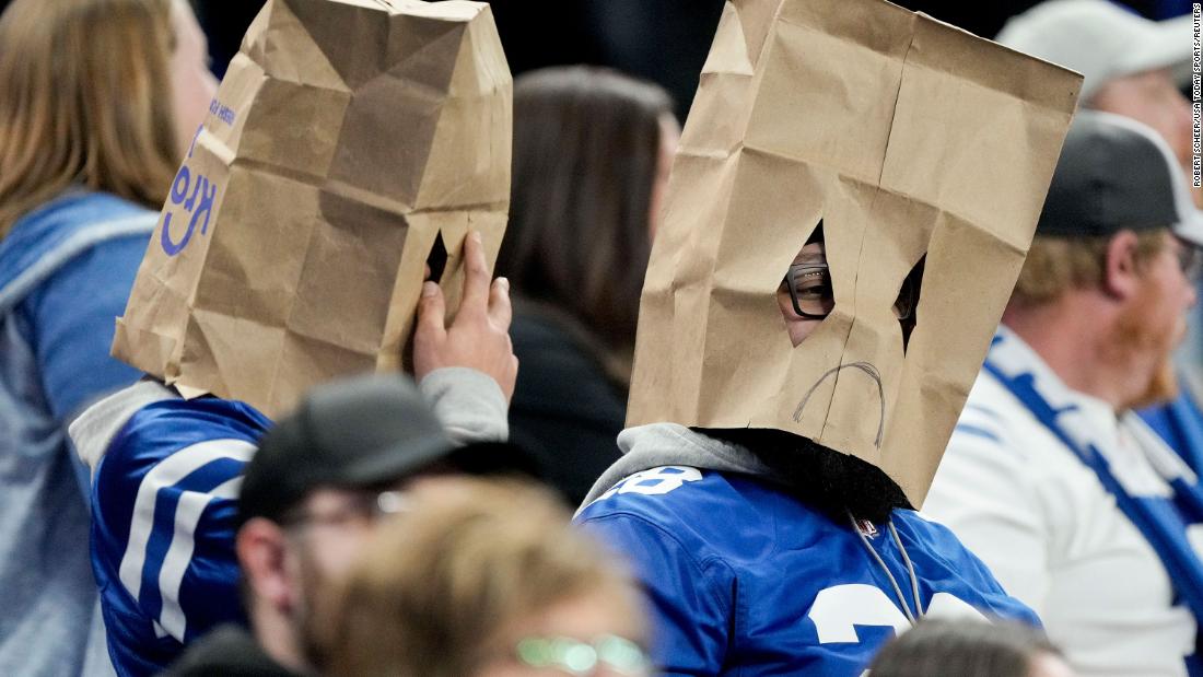 Indianapolis Colts fans sit in the stands wearing sad face paper bag masks during a game against the Houston Texans at Lucas Oil Stadium. The Colts lost their last seven games of the season -- including Sunday&#39;s 32-31 defeat to the Texans -- to finish 4-12-1 for the season, leaving them with the No. 4 pick in the 2023 NFL draft. 