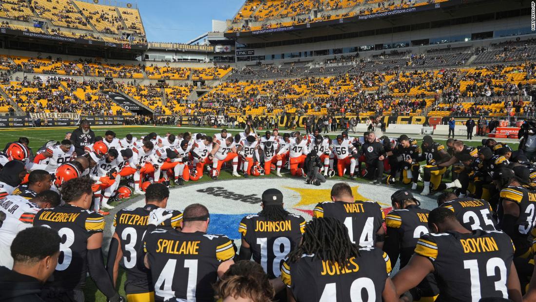 The Cleveland Browns and Pittsburgh Steelers kneel in prayer for Buffalo Bills safety Damar Hamlin before playing on December 8. The Steelers would go on to win 28-14. 