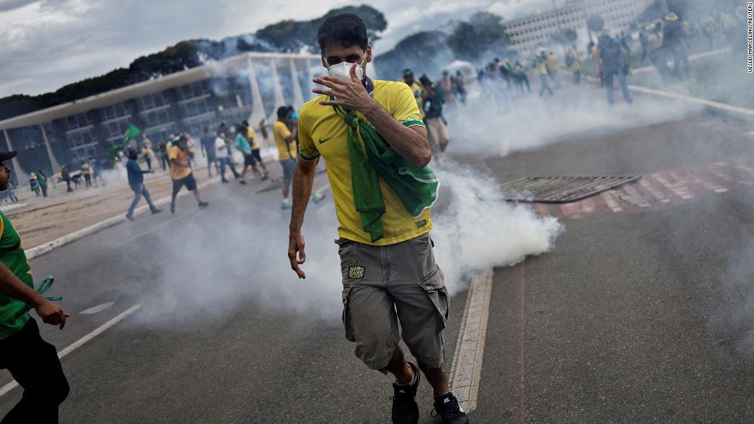 Supporters of former President Jair Bolsonaro demonstrate outside Planalto Palace.