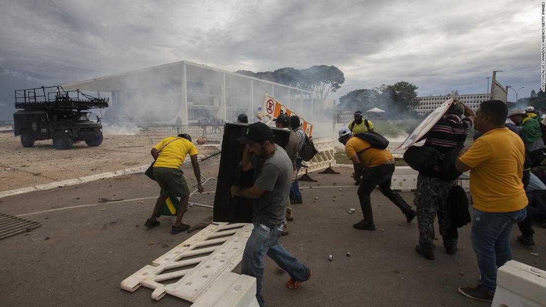 Supporters of former President Jair Bolsonaro clash with security forces as they break into Planalto Palace and raid the Supreme Court in Brasilia.