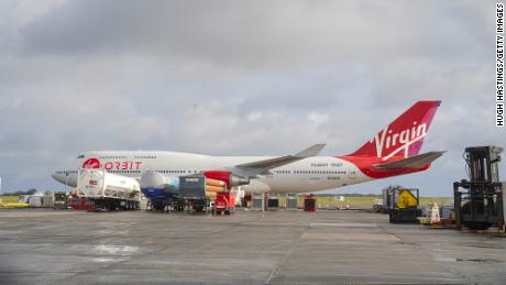 Virgin Orbit&#39;s Cosmic Girl 747, which is designed to carry the company&#39;s LauncherOne rocket beneath its wing, sits on the apron runway surrounded by technical service equipment at Cornwall Airport on January 8 in Newquay, England.