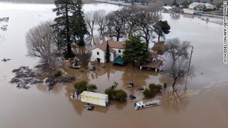 TOPSHOT - This aerial view shows a flooded home partially underwater in Gilroy, California, on January 9, 2023. - A massive storm called a bomb cyclone&quot; by meteorologists has arrived and is expected to cause widespread flooding throughout the state. (Photo by JOSH EDELSON / AFP) (Photo by JOSH EDELSON/AFP via Getty Images)