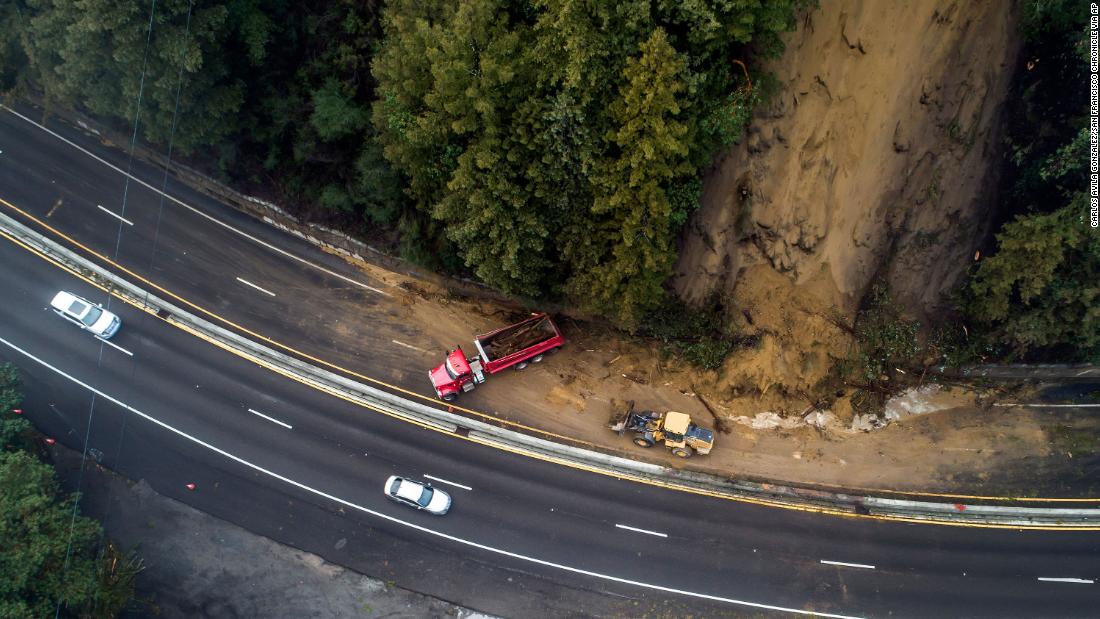 Crews work to clear a mudslide on Highway 17 in Scotts Valley.