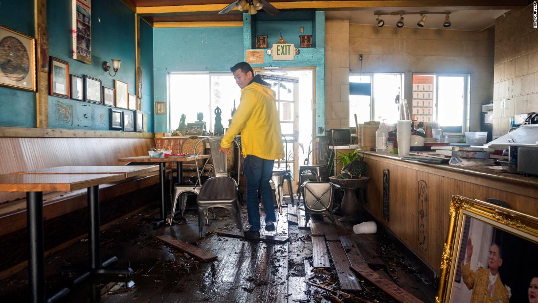 Dominic King, owner of the restaurant My Thai Beach, surveys storm damage at his business in Capitola.