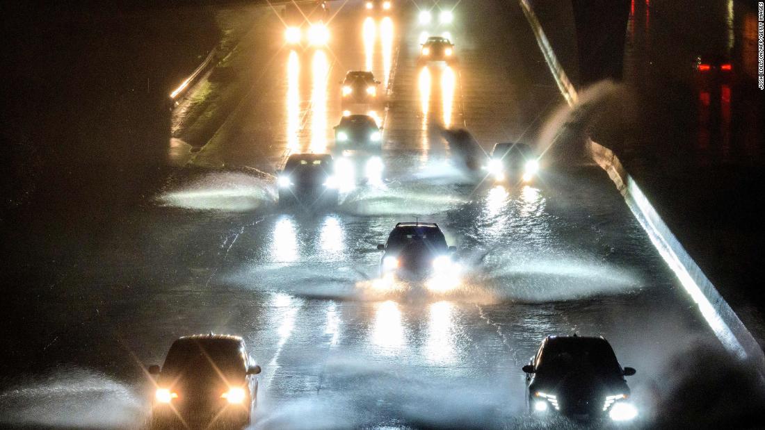 Drivers in San Francisco barrel into standing water on Interstate 101 on January 4.