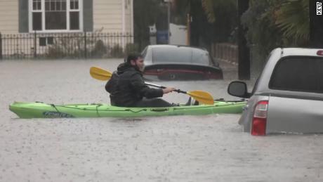 A man kayaks through a neighborhood Tuesday in Santa Barbara, California.