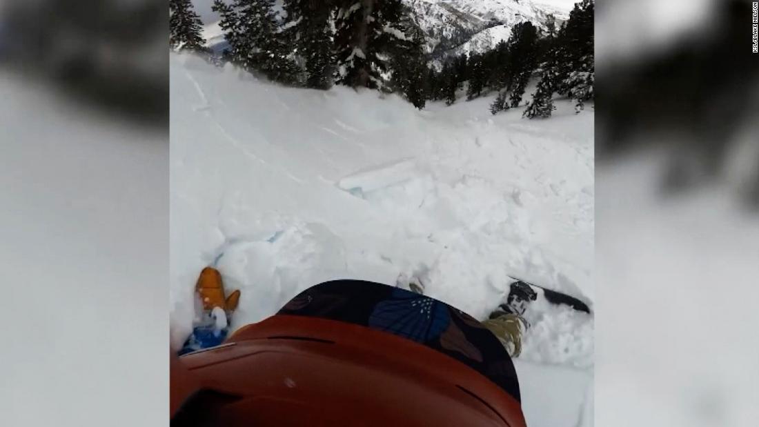See moment snowboarder is swept away by avalanche