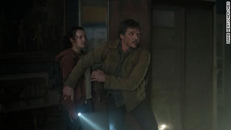 Bella Ramsey&#39;s Ellie is shielded by Pedro Pascal&#39;s Joel in &quot;The Last of Us.&quot; 
