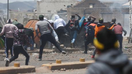 Demonstrators pictured on January 9, 2023 clash with security forces during a protest near the Juliaca airport in Peru. 