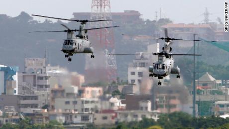 In this Aug. 16, 2012 photo, CH-46 helicopters take off from the US Marine Corps base in Futenma , in Okinawa, Japan. 