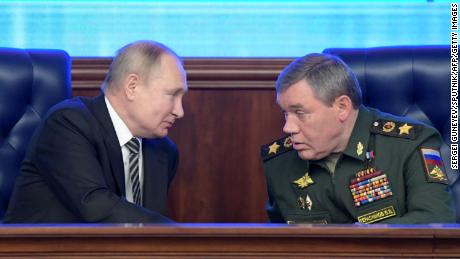 Russian President Vladimir Putin listens to Valery Gerasimov during the annual meeting of the Defence Ministry board in Moscow on December 21, 2021.