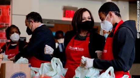 Vice President Kamala Harris (2nd L) talks with volunteers as they fill bags with food at Martha&#39;s Table, a community based education, health and family services organization, during Martin Luther King Jr. Day on January 17, 2022 in Washington, DC. 