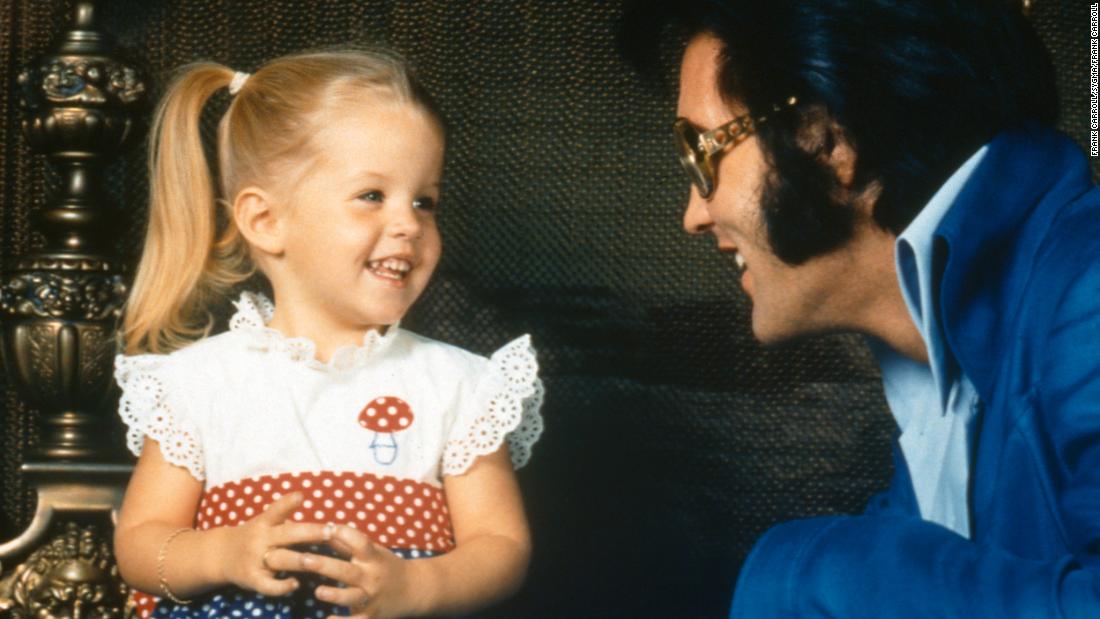 Lisa Marie Presley takes a picture with her dad in 1973. Her parents separated in 1972 when she was just 4 years old.