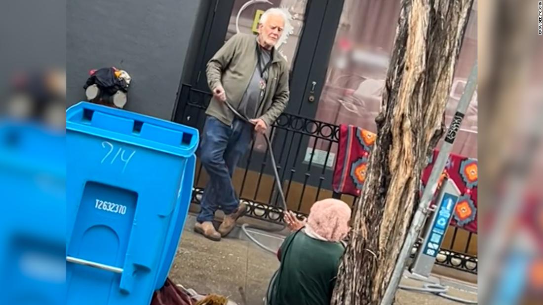Gallery owner sprays homeless woman with water