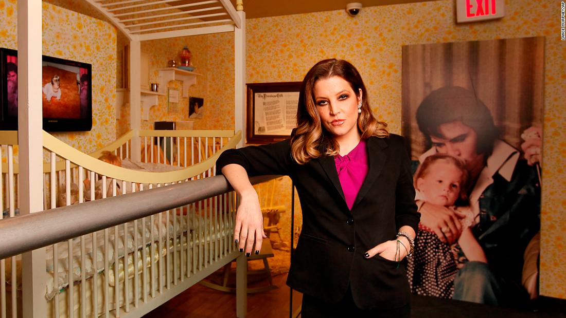 Presley stands next to her childhood crib displayed with other mementos in the exhibit &quot;Elvis Through His Daughter&#39;s Eyes&quot; at Elvis&#39; Graceland mansion in Memphis in 2012.
