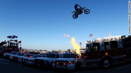 Motorcycle daredevil Robbie Knievel jumps a line of police cars, ambulances and a fire truck spanning 200 feet in his &quot;Above the Law&quot; jump prior to the IZOD IndyCar Series Firestone 550k at Texas Motor Speedway June 5, 2010 in Fort Worth, Texas.