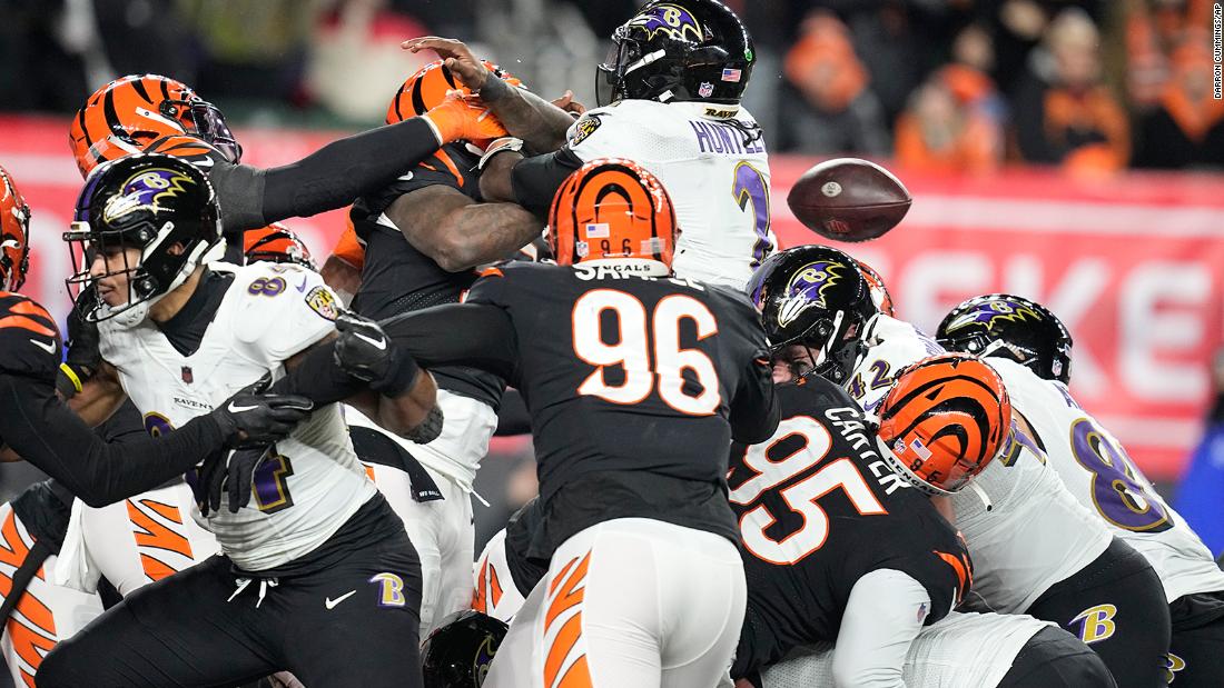 Baltimore Ravens quarterback Tyler Huntley loses the ball as it is knocked away by Cincinnati Bengals linebacker Logan Wilson. Bengals defensive end Sam Hubbard picked up the fumble and returned it for a 98-yard touchdown in a game-changing moment in Cincinnati&#39;s 24-17 victory. 