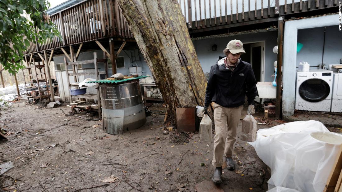 Joey Klien salvages items from his house on January 16 after part of it was flooded in Carmel Valley.