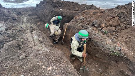 Ukrainian soldiers digging trenches in Bakhmut.