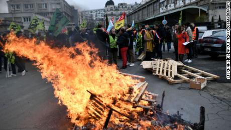 Wooden pallets burn, as demonstrators gather during a rally called by French trade unions outside the Gare de Lyon, in Paris on January 19, 2023.
