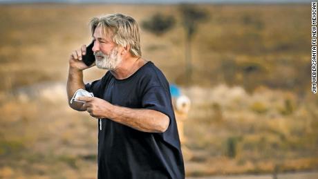 A distraught Alec Baldwin lingers in the parking lot outside the Santa Fe County Sheriff&#39;s offices on Camino Justicia after being questioned on Oct. 20, 2021 about a shooting when a prop gun misfired earlier in the day on a local movie set.