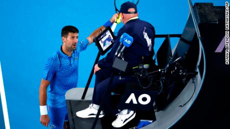 Novak Djokovic argues with the chair umpire during his second round match against Enzo Couacaud.