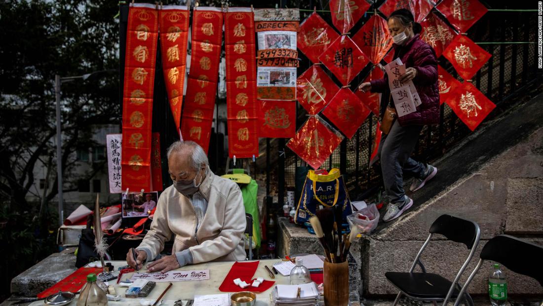 A man writes messages on red paper in Hong Kong on Thursday, January 19.