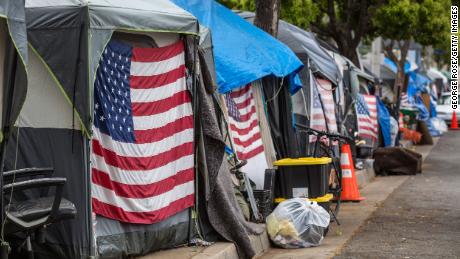 Homeless veterans are housed in 30 tents on a sidewalk along busy San Vicente Boulevard outside the Veteran&#39;s Administration campus in Los Angeles on April 22, 2021.