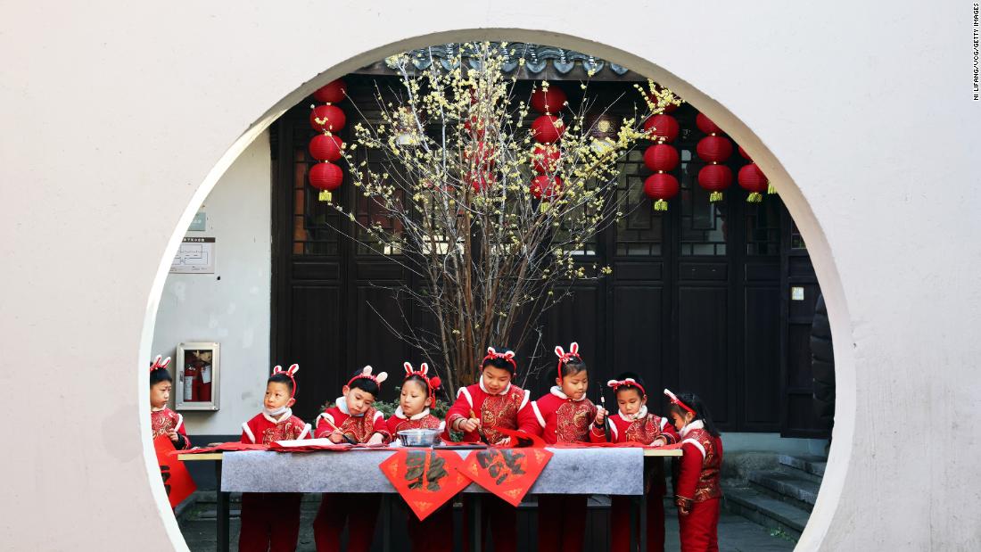 Children wearing bunny ears write the Chinese character &quot;Fu,&quot; meaning &quot;good luck,&quot; on Monday, January 16 in Huzhou, China. The Year of the Rabbit starts on January 22.