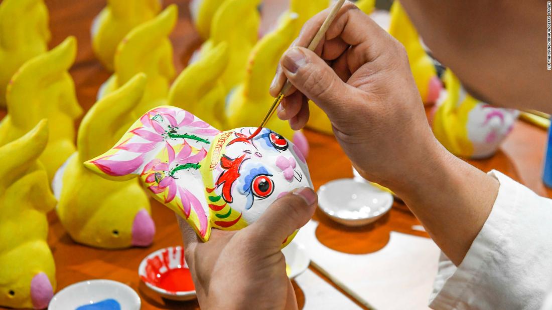 An artist colors a clay figurine at a workhop in north China&#39;s Hebei Province on January 16. As the Lunar New Year approaches, decorative items featuring rabbits, one of the 12 Chinese Zodiac animals, are sweeping the streets.