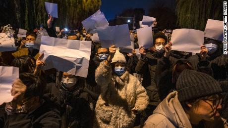 People hold up blank pieces of paper during a protest against China&#39;s zero-Covid measures on November 27, 2022 in Beijing, China. 
