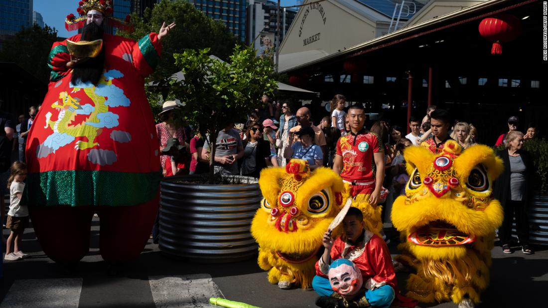 People gather around to watch members of the Vietnamese Buddhist Youth Association perform the dragon dance at Victoria Market on January 22, in Melbourne, Australia.