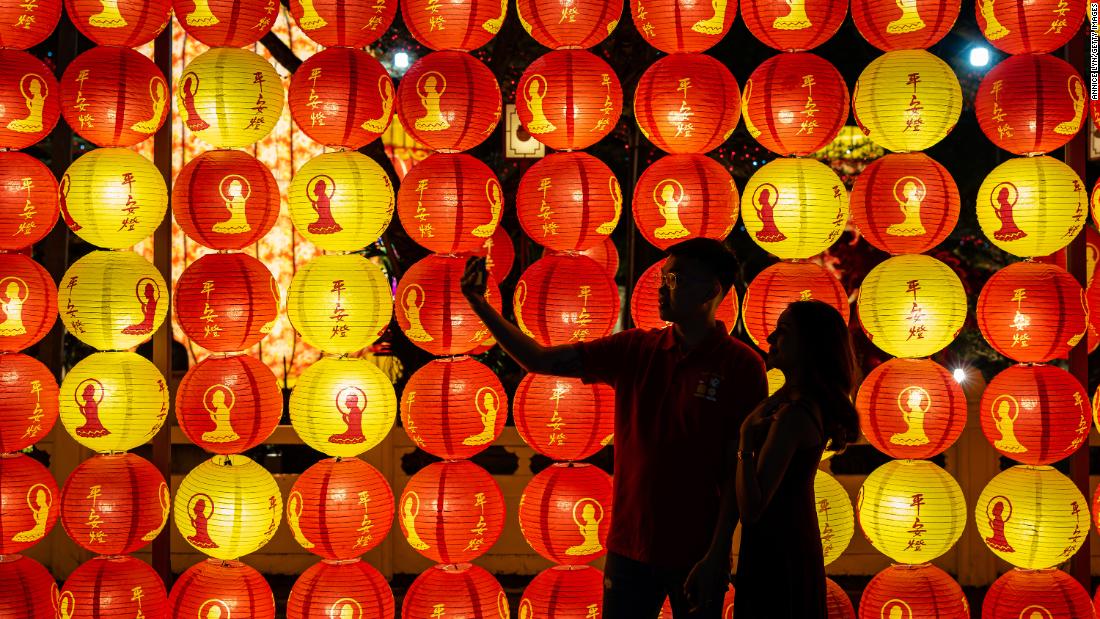 A couple take a selfie in front of lanterns decoration at Fo Guang Shan Dong Zen Buddhist Temple on January 21, in Jenjarom, Selangor, Malaysia. 