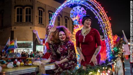 Drag queens Felicia Enspire, Alexandria Van Cartier and Sedonya Face sit on a float at a Christmas parade in Taylor, Texas, on December 3, 2022.