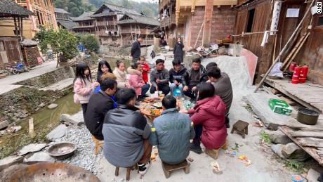 Selina speaking with villagers during their Lunar New Year feast.