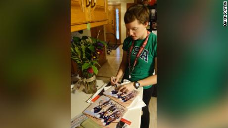 Kelly signing pictures from the Olympics for fans in the family home in Arden Hills, Minnesota. Kelly continually received requests for autographed pictures from fans, particularly from Europe, and a surprising number from Germany, her father said, adding that she always responded. 