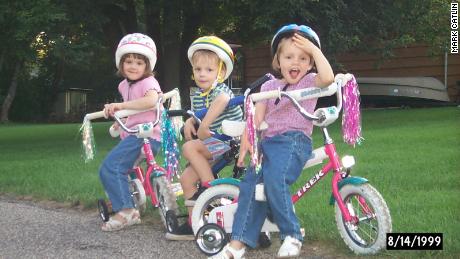 Kelly, along with her siblings Colin and Christine, pictured as a child on a bike ride in Minneapolis. Cycling was a passion from an early age, according to her father. 