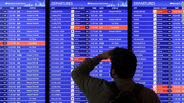 A traveler looks at a flight information board at Ronald Reagan Washington National Airport on January 11, 2023 in Arlington, Virginia. 