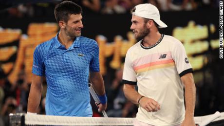 Djokovic and Paul chat at the net during their semifinal at the Australian Open.