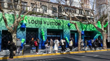 People posing for photos at a pop-up Louis Vuitton shop in Shanghai in January 2022. 