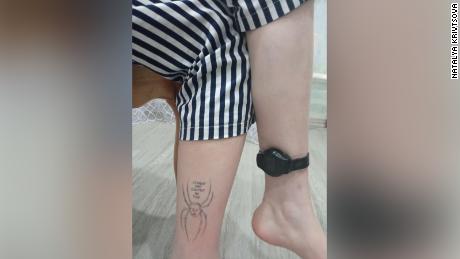 Olesya wears a tracking bracelet on one ankle, and a tattoo on the other which reads &quot;Big Brother is Watching You,&quot; with Russian President Vladimir Putin&#39;s face attached to the body of a spider.