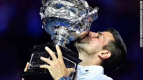 Serbia&#39;s Novak Djokovic celebrates with the Norman Brookes Challenge Cup trophy following his victory against Greece&#39;s Stefanos Tsitsipas in the men&#39;s singles final match on day fourteen of the Australian Open tennis tournament in Melbourne on January 29, 2023.