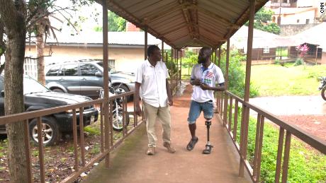 Samai (left) meets with SLASA player Maxwell Fornah at the National Rehabilitation Center in Sierra Leone.