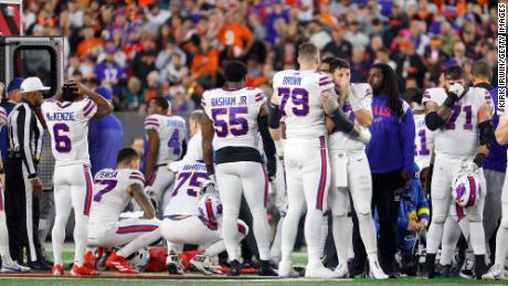 Buffalo Bills players react after Hamlin suffered a cardiac arrest on the field during a game against the Bengals.