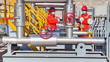 Technicians inspect a natural gas pipeline connected to Russia at a gas-distributing station in northern China&#39;s Hebei province in November 2022.