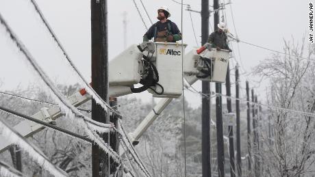 Austin Energy linemen work to restore power on ice-covered lines Wednesday in Austin, Texas. 