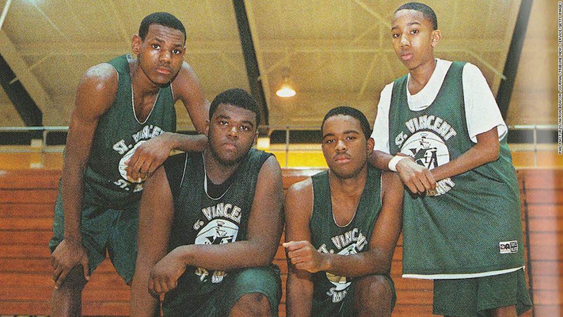 James, left, poses with some of his teammates at St. Vincent-St. Mary High School during his freshman year.