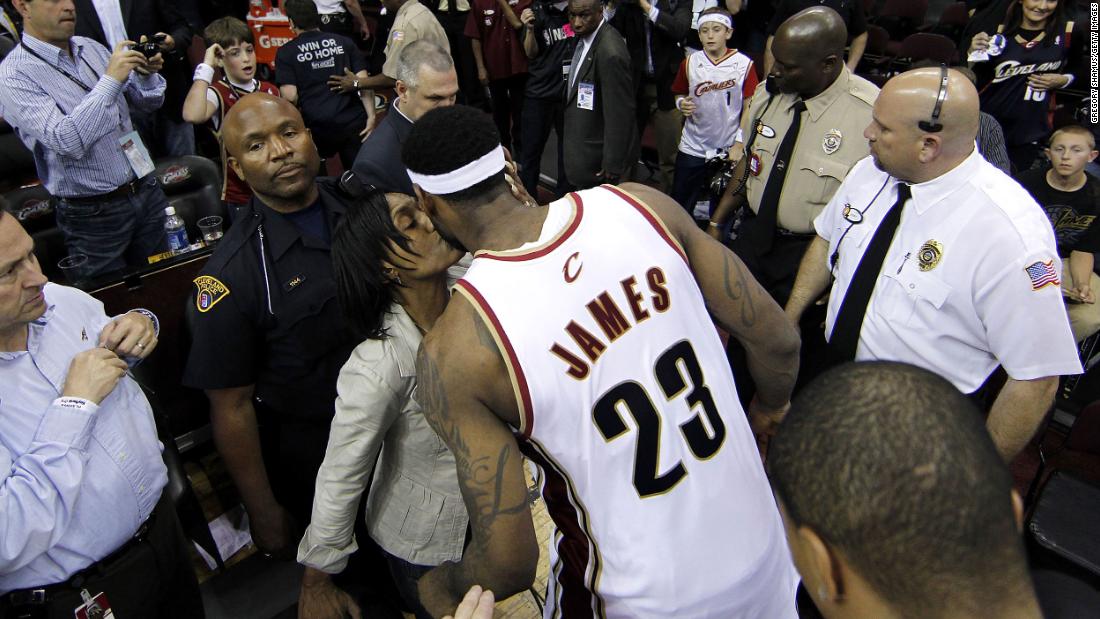 James gets a kiss from his mother after a playoff game in May 2010.